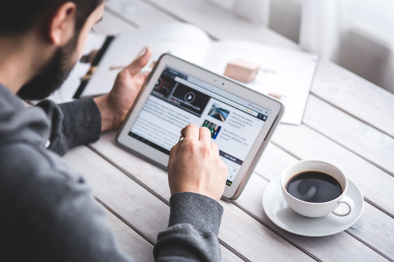 Man, reading, touchscreen — Exploring Crypto News on Regulations, Exchanges, and Adoption